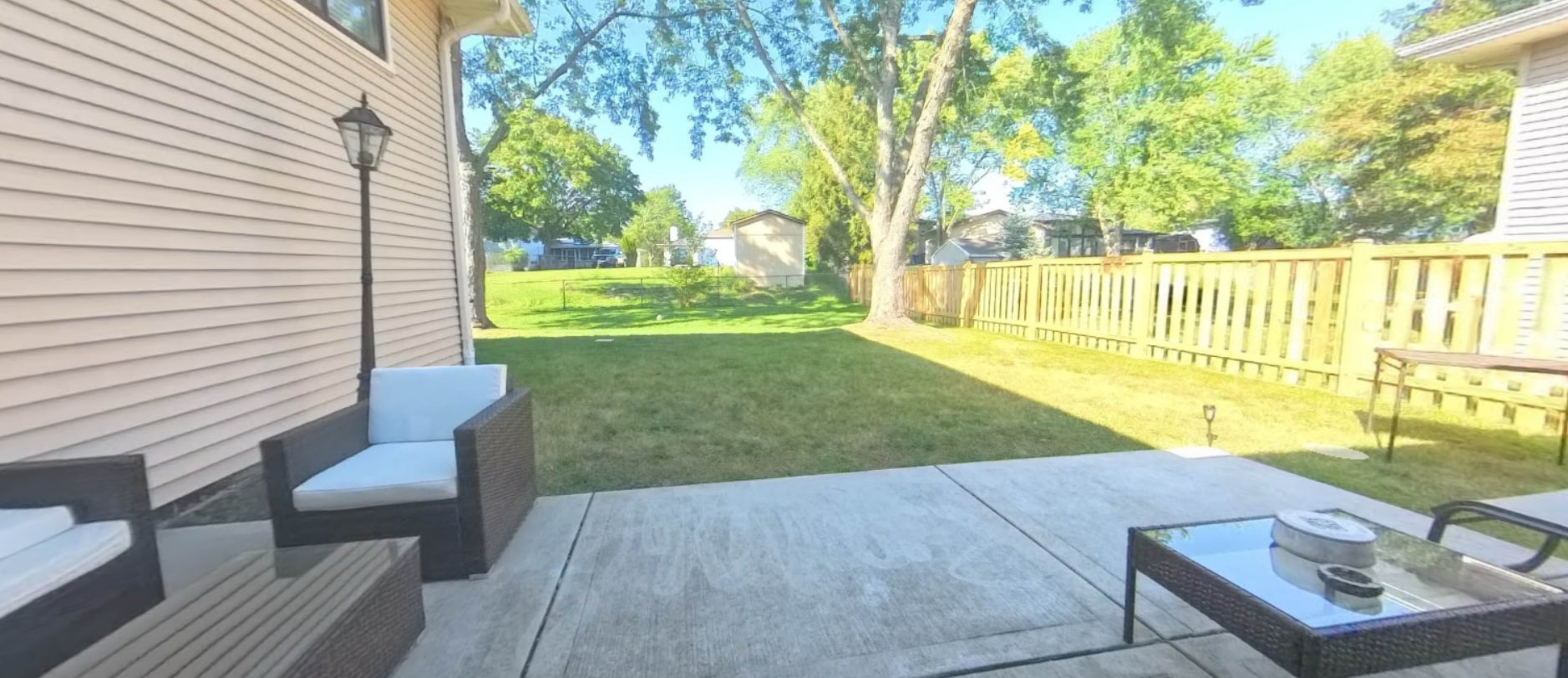 Spacious backyard and patio shown inside the sample virtual tour